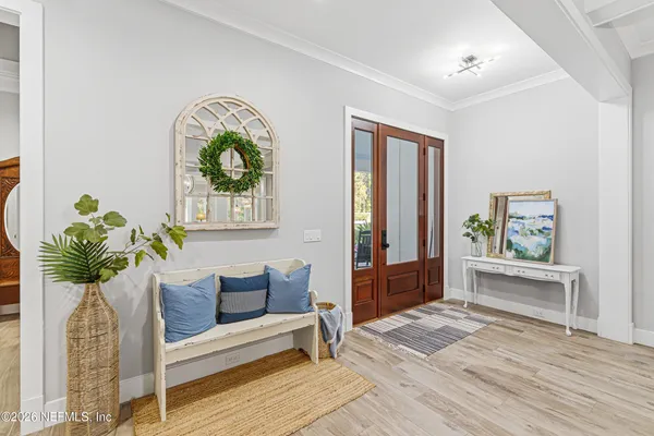a view of a patio with a table chairs and a yard