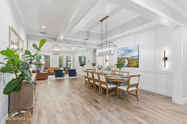 a view of a house with backyard and a tree