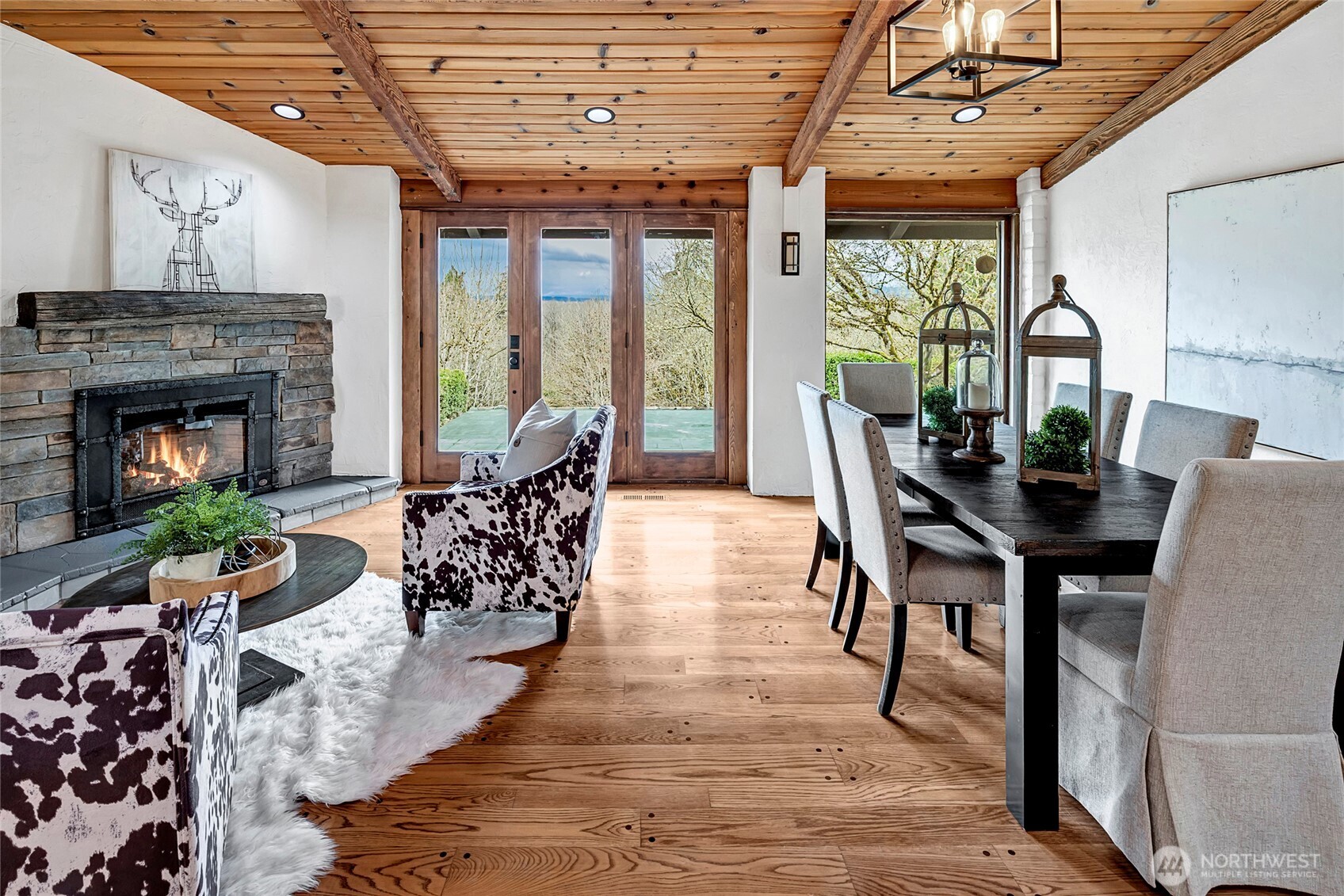 16121 High Bridge Road Monroe, WA 98272 - Photo 16 of 40 a dining room with furniture a fireplace and wooden floor