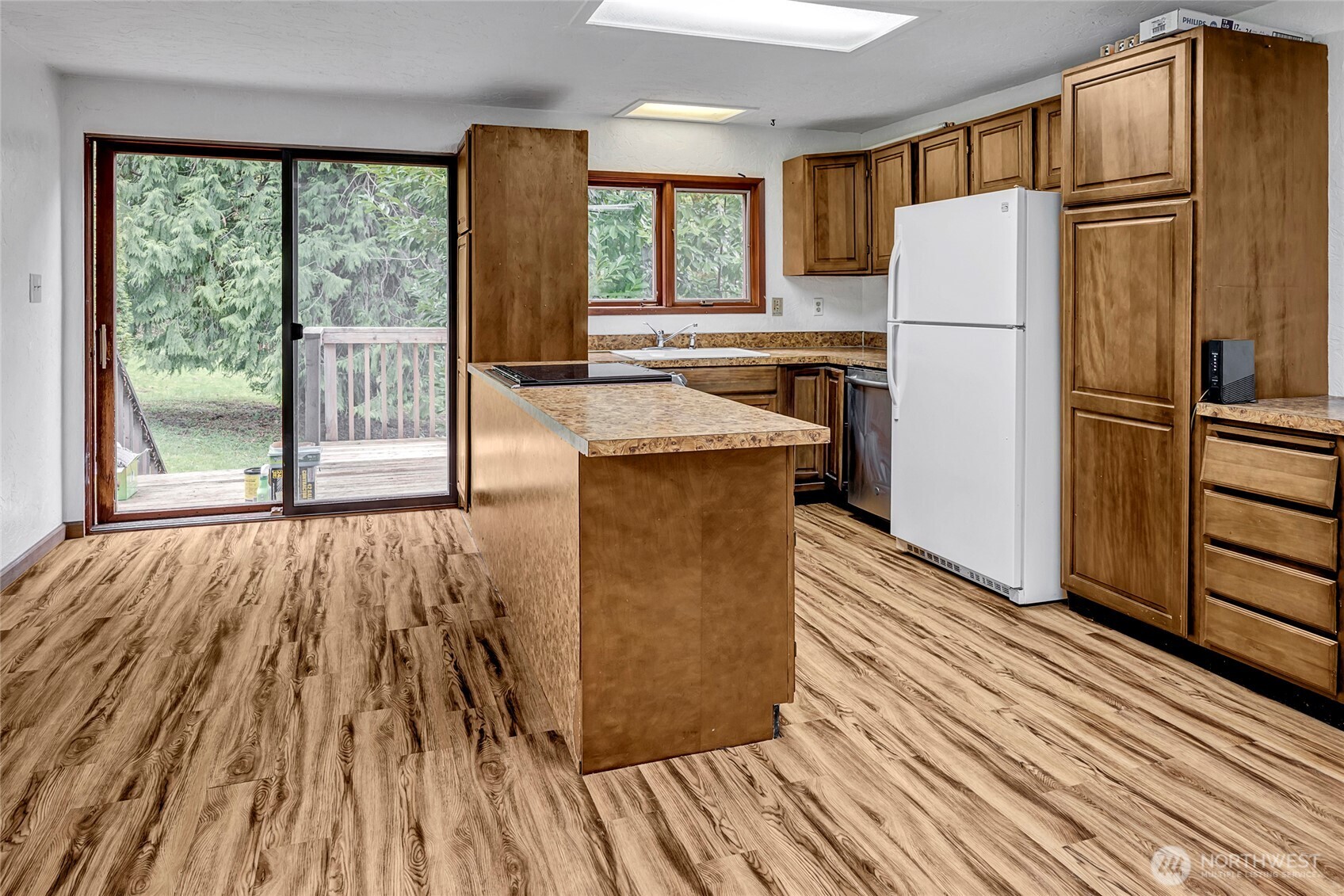 16121 High Bridge Road Monroe, WA 98272 - Photo 32 of 40 a kitchen with wooden floors and refrigerator