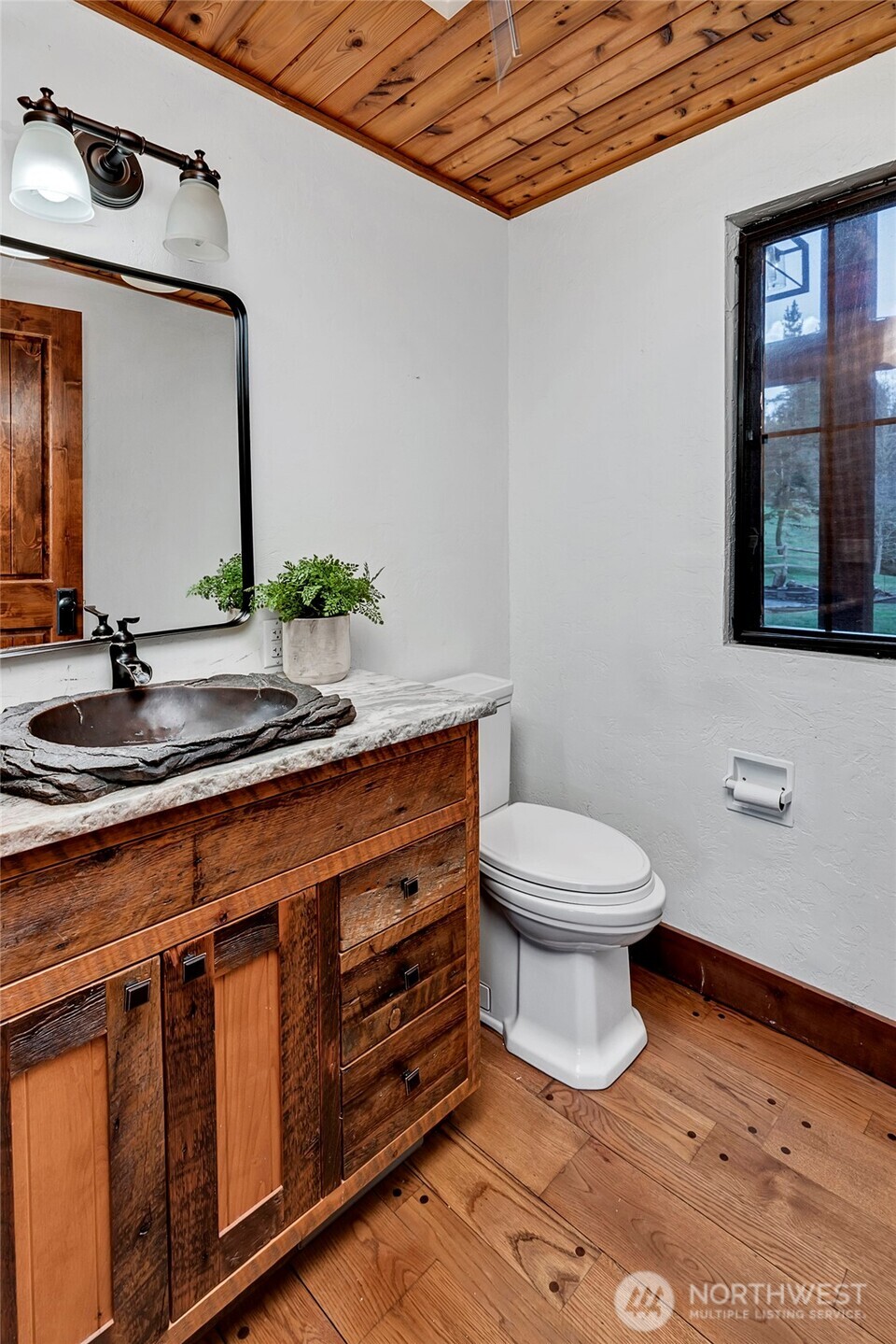 16121 High Bridge Road Monroe, WA 98272 - Photo 8 of 40 a bathroom with a toilet a sink and mirror