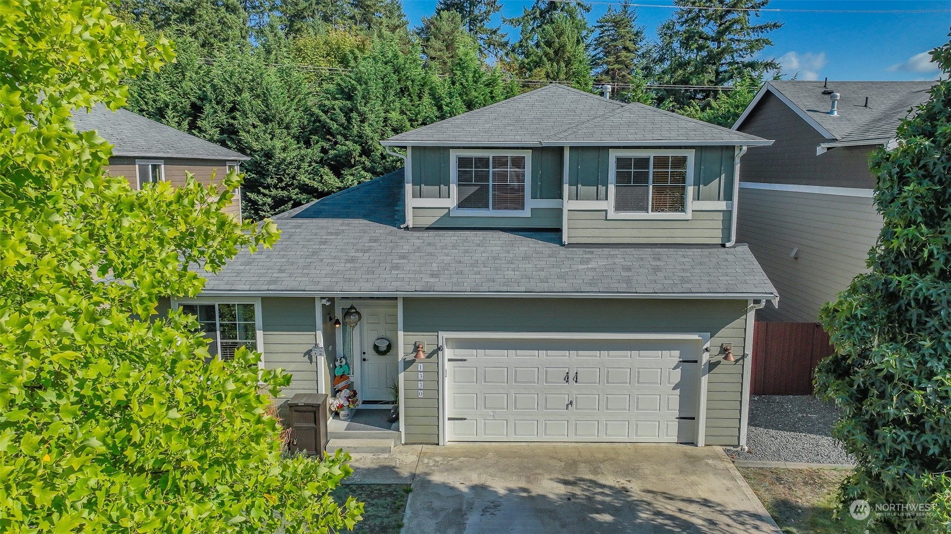 a front view of a house with a garden and plants