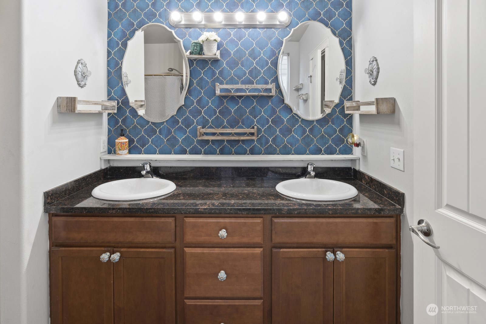 1330 Farina Loop Southeast Olympia, WA 98513 - Photo 16 of 35 a bathroom with a granite countertop sink a mirror and vanity