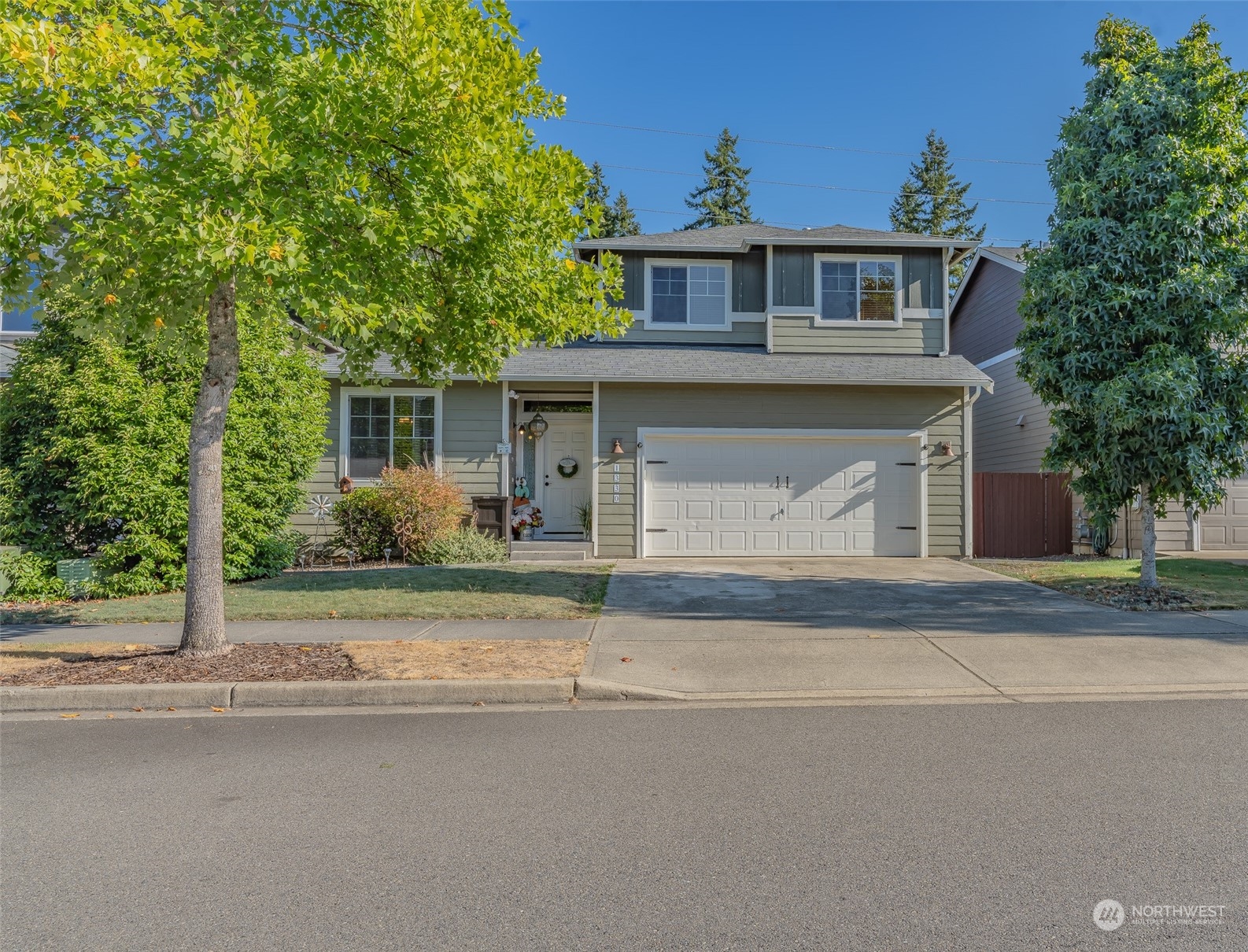 1330 Farina Loop Southeast Olympia, WA 98513 - Photo 2 of 35 a front view of a house with a yard and garage