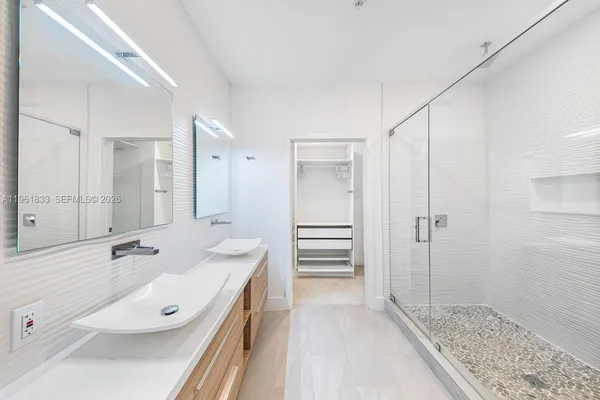 a bathroom with a tub sink and mirror