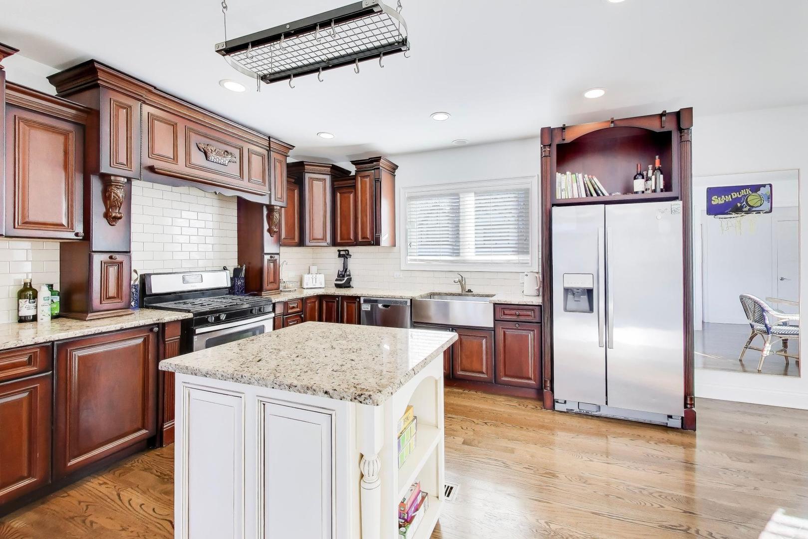 229 North Myrtle Avenue Elmhurst, IL 60126 - Photo 14 of 43 a kitchen with stainless steel appliances granite countertop a refrigerator a sink a stove a microwave and island