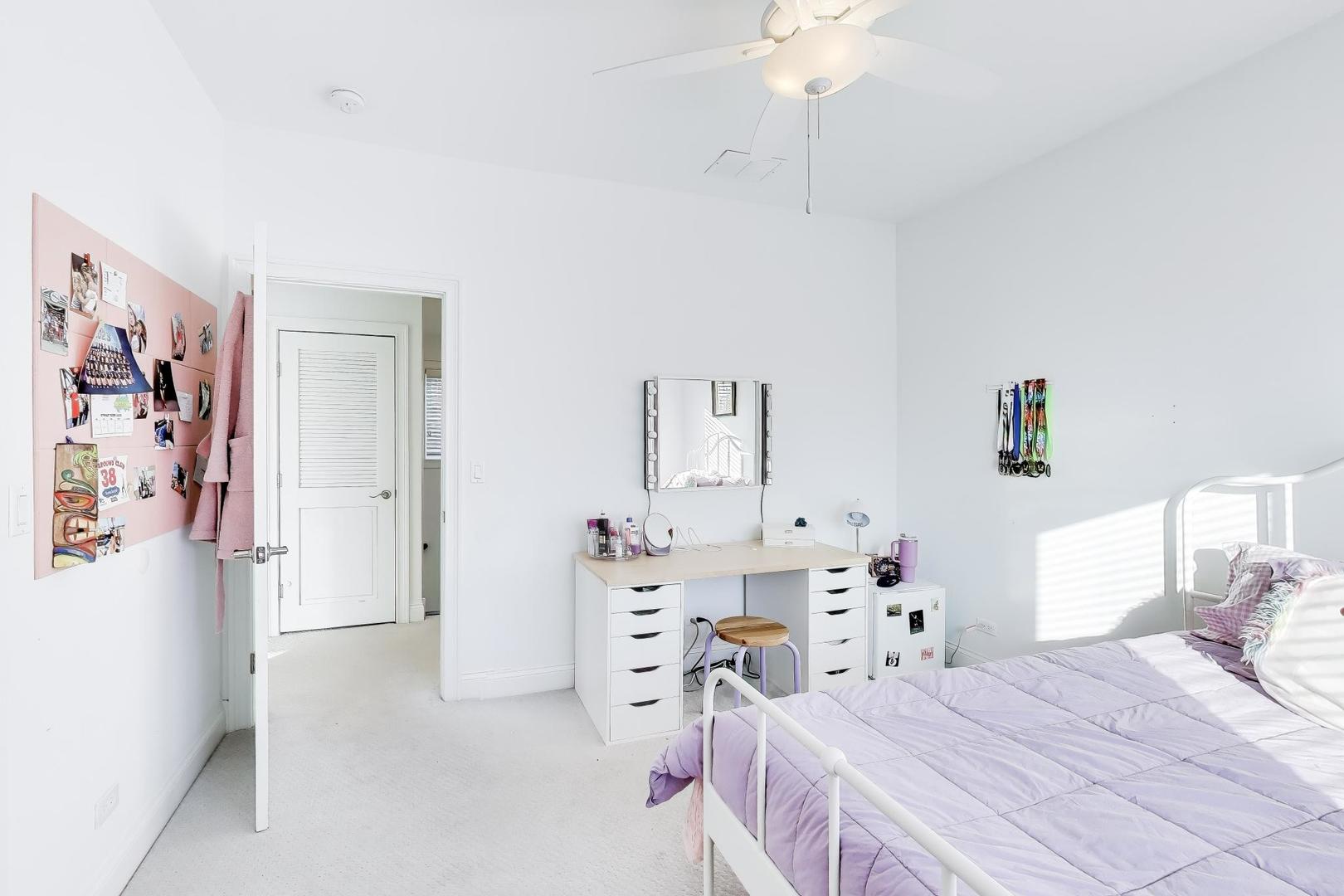 229 North Myrtle Avenue Elmhurst, IL 60126 - Photo 27 of 43 a bedroom with a bed and a chandelier