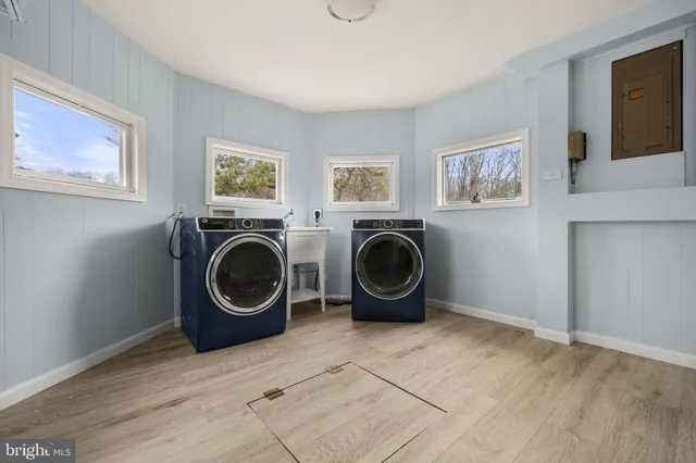 a living room with furniture and a washer dryer