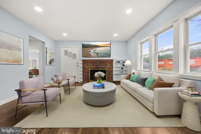 a living room with furniture a fireplace and window