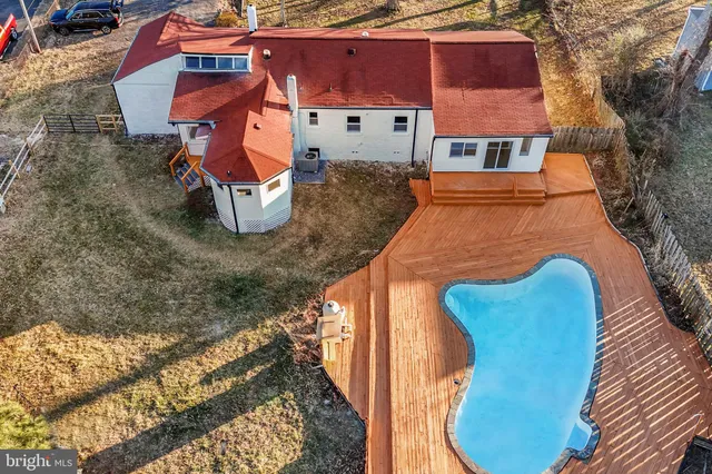 an aerial view of a house with a yard and sitting area