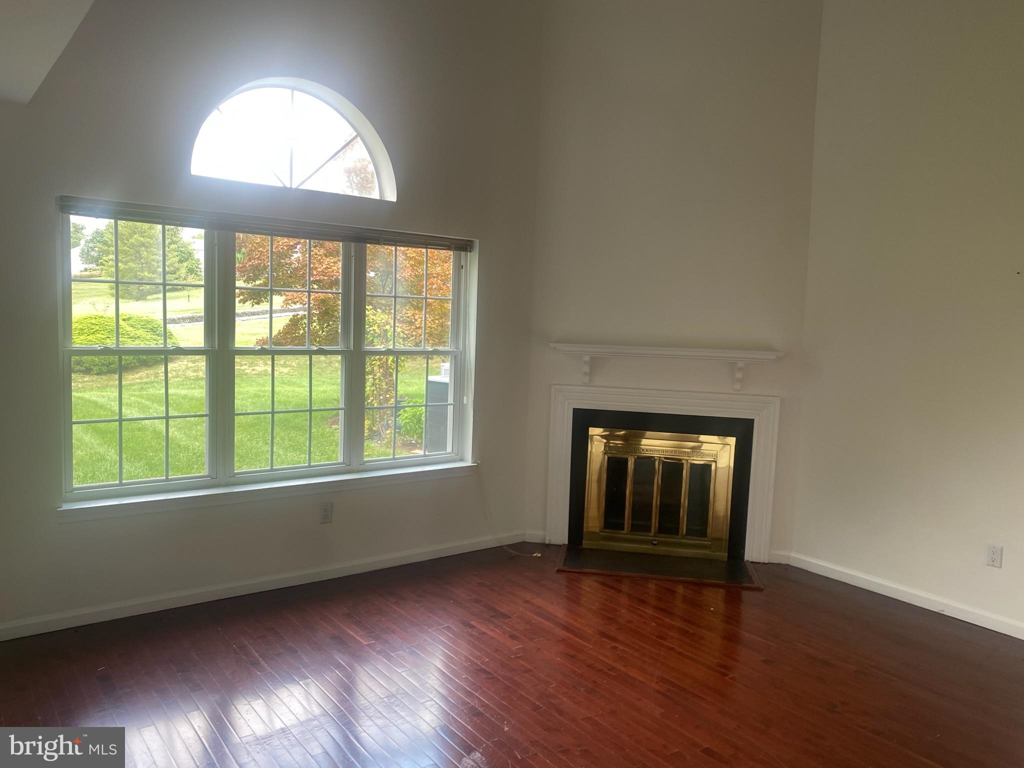 113 North Park Road Newtown, PA 18940 - Photo 3 of 15 an empty room with wooden floor and windows