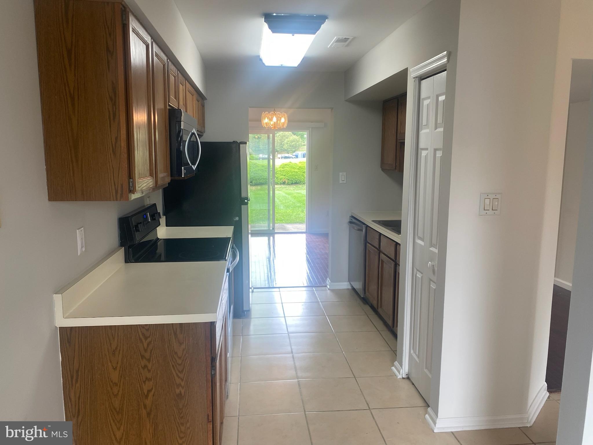 113 North Park Road Newtown, PA 18940 - Photo 7 of 15 a kitchen with granite countertop a refrigerator and a stove top oven