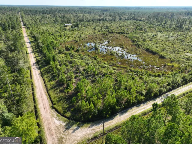 a view of a green field with lots of bushes
