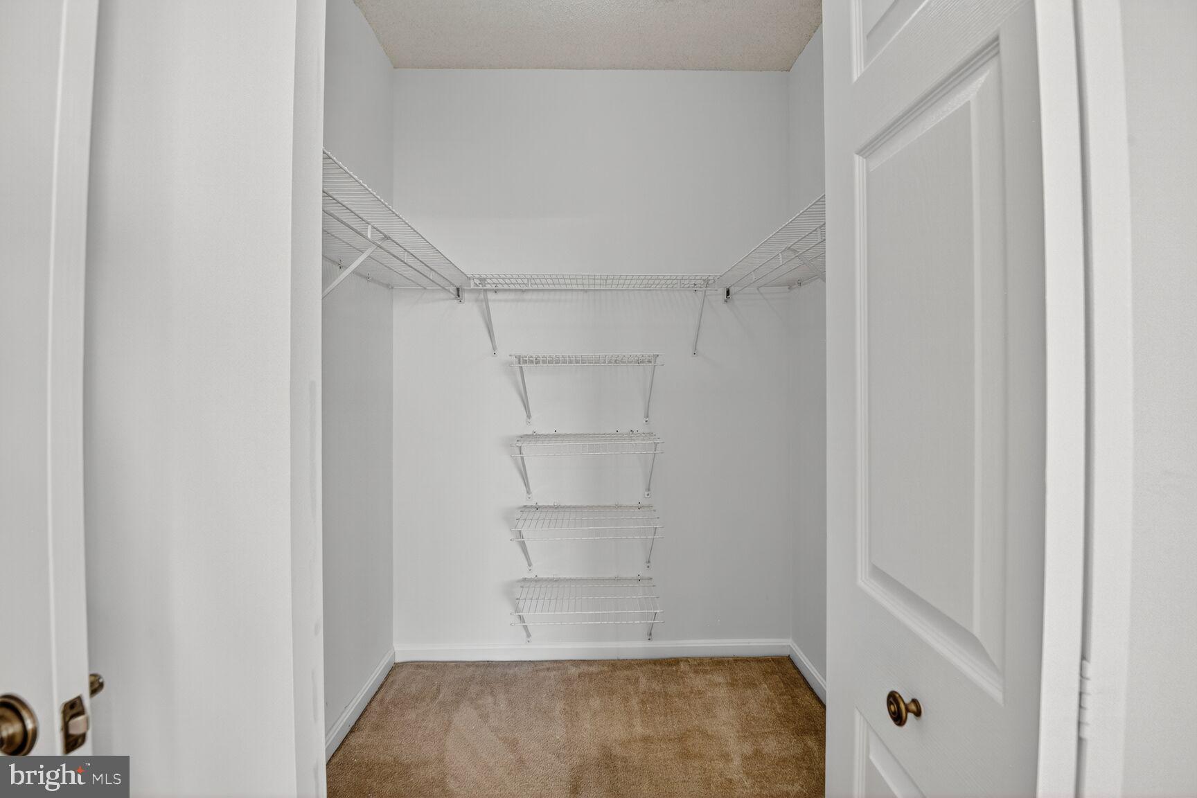 3200 North Leisure World Boulevard, Unit 918 Silver Spring, MD 20906 - Photo 13 of 22 a view of walk in closet with empty racks