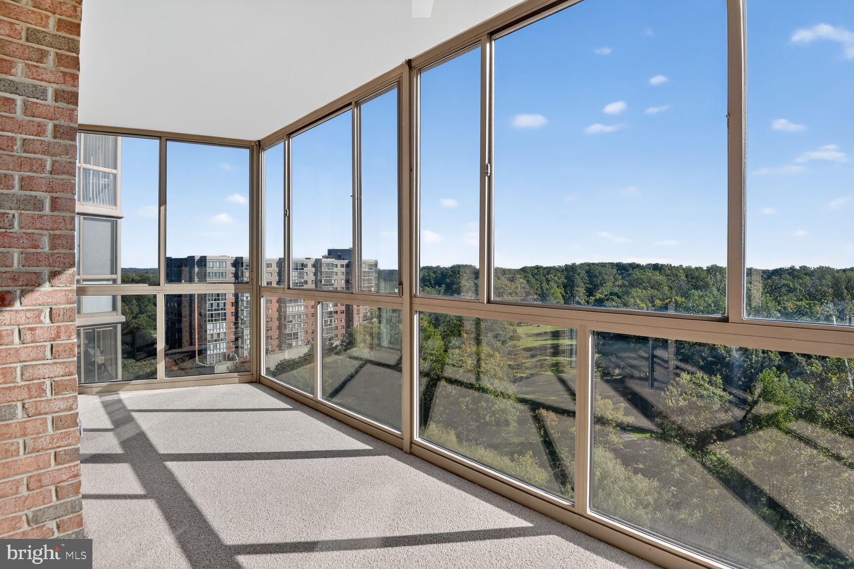 3200 North Leisure World Boulevard, Unit 918 Silver Spring, MD 20906 - Photo 3 of 22 a view of a balcony with floor to ceiling windows with wooden floor