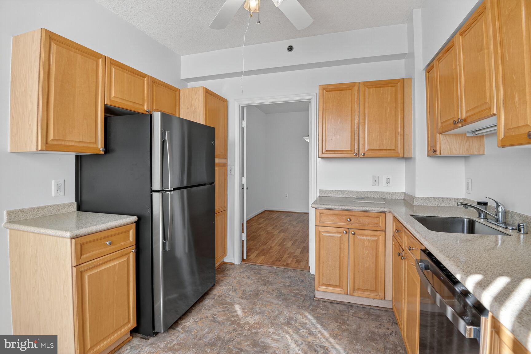 3200 North Leisure World Boulevard, Unit 918 Silver Spring, MD 20906 - Photo 6 of 22 a kitchen with stainless steel appliances granite countertop a refrigerator and a sink