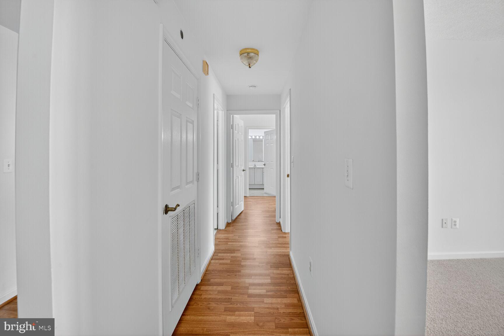 3200 North Leisure World Boulevard, Unit 918 Silver Spring, MD 20906 - Photo 10 of 22 a view of a hallway with wooden floor