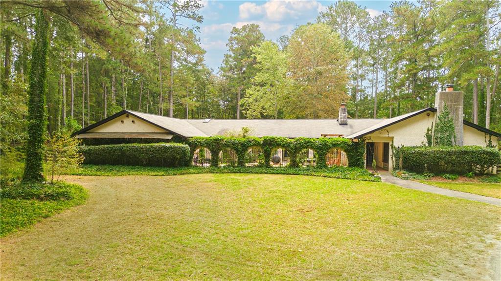 2301 Brooks Road Southeast Dacula, GA 30019 - Photo 3 of 63 a view of swimming pool with lawn chairs and wooden fence