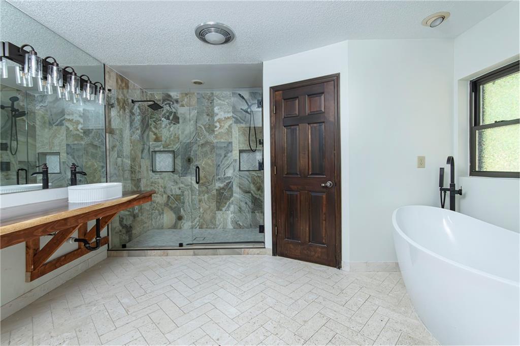 2301 Brooks Road Southeast Dacula, GA 30019 - Photo 40 of 63 a bathroom with a bathtub and a sink