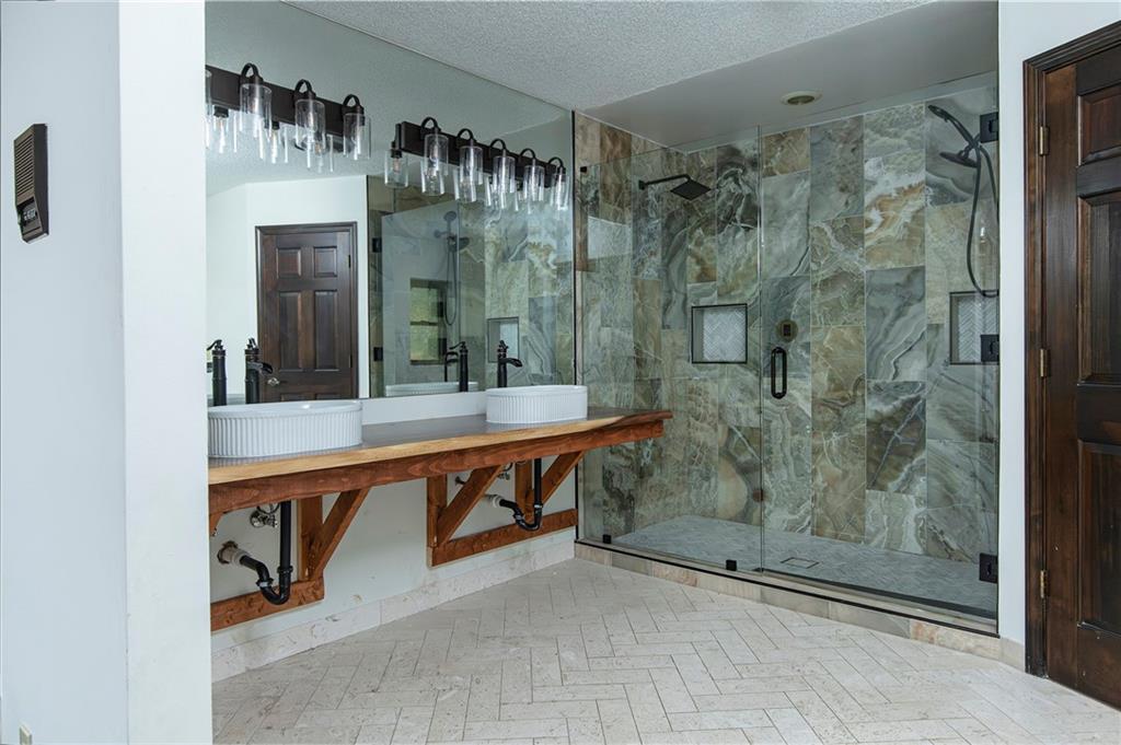 2301 Brooks Road Southeast Dacula, GA 30019 - Photo 42 of 63 a bathroom with a shower sink and mirror