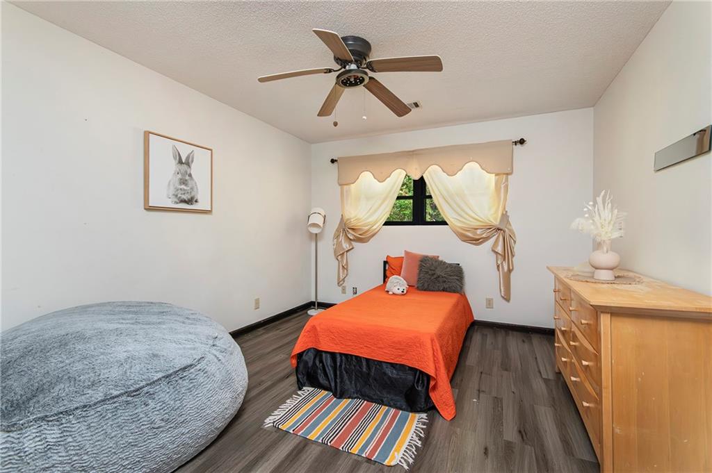 2301 Brooks Road Southeast Dacula, GA 30019 - Photo 43 of 63 a bedroom with a bed and a chandelier