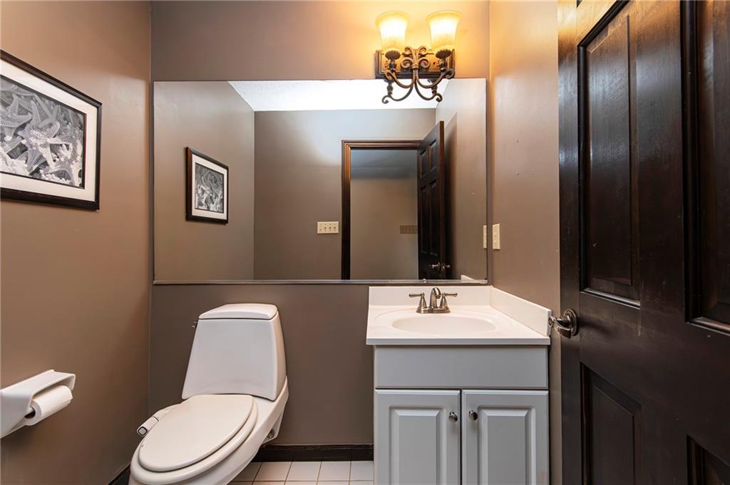 2301 Brooks Road Southeast Dacula, GA 30019 - Photo 52 of 63 a bathroom with a sink vanity mirror and toilet