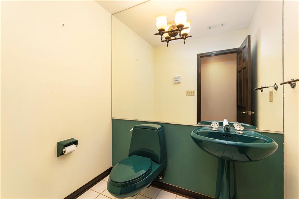 2301 Brooks Road Southeast Dacula, GA 30019 - Photo 53 of 63 a bathroom with a sink and a mirror