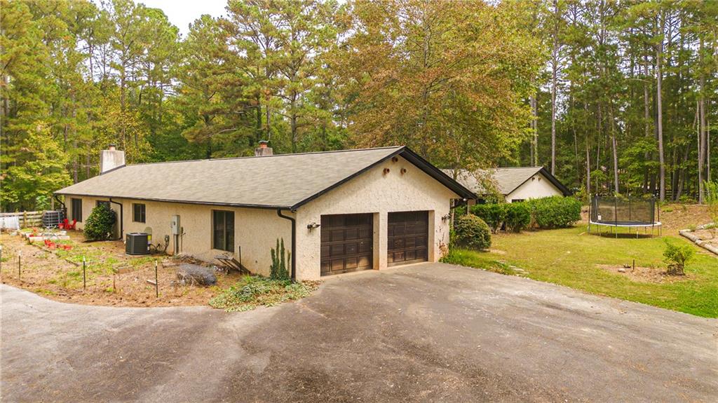 2301 Brooks Road Southeast Dacula, GA 30019 - Photo 8 of 63 a view of a house with pool and yard