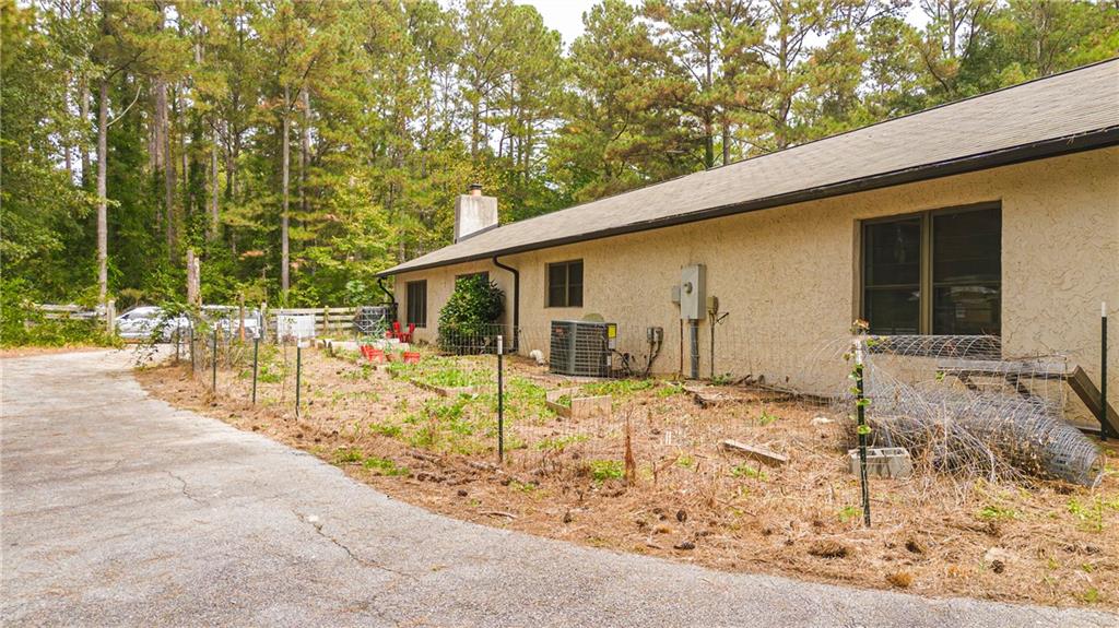 2301 Brooks Road Southeast Dacula, GA 30019 - Photo 9 of 63 a backyard of a house with table and chairs