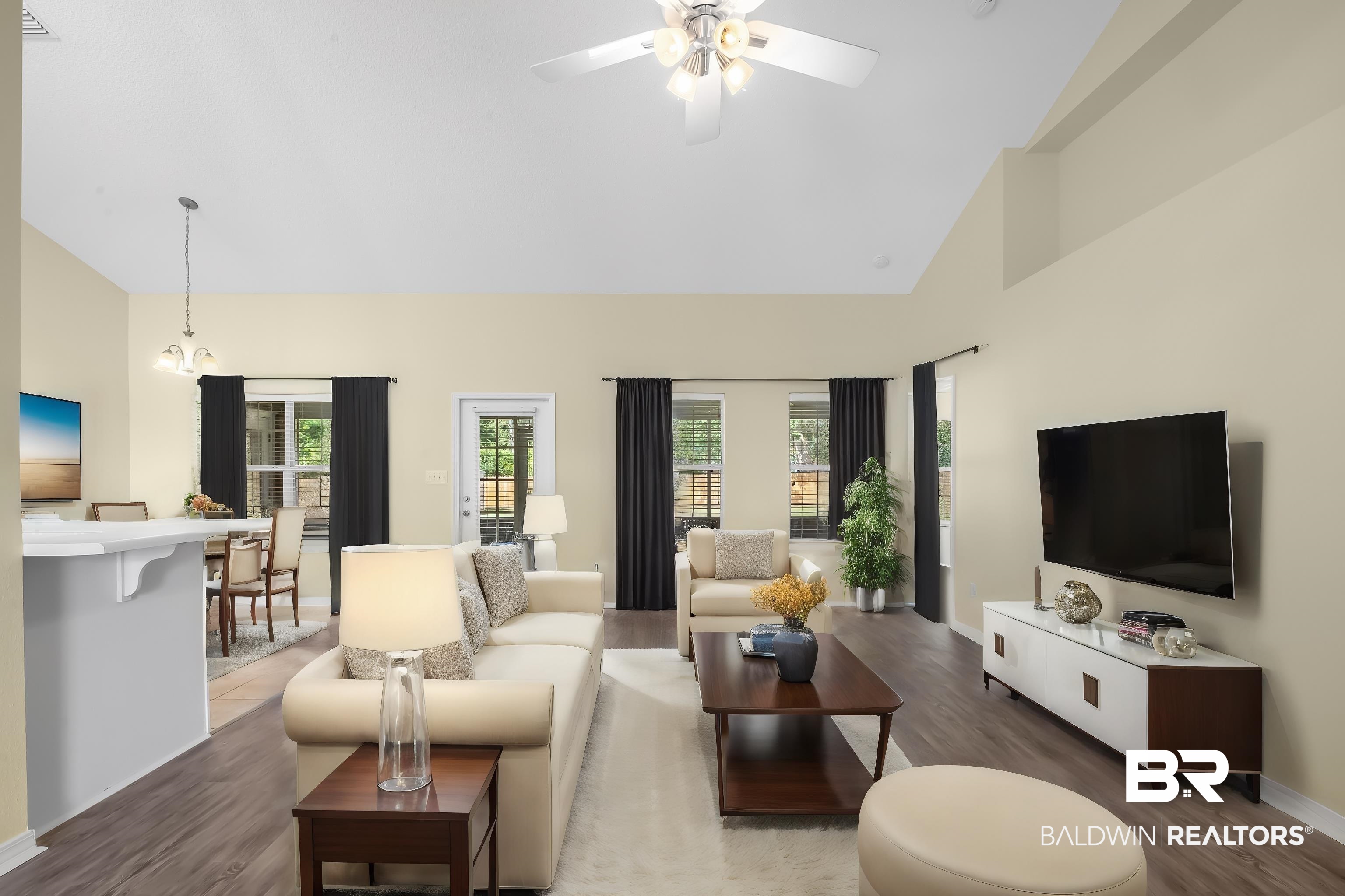12443 Venice Boulevard Foley, AL 36535 - Photo 22 of 59 Living room with high vaulted ceiling, ceiling fan with notable chandelier, and dark hardwood / wood-style flooring