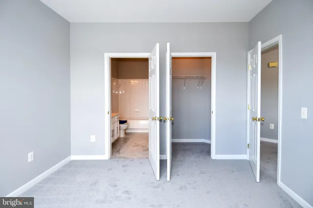 a view of a room with wooden floor and bathroom