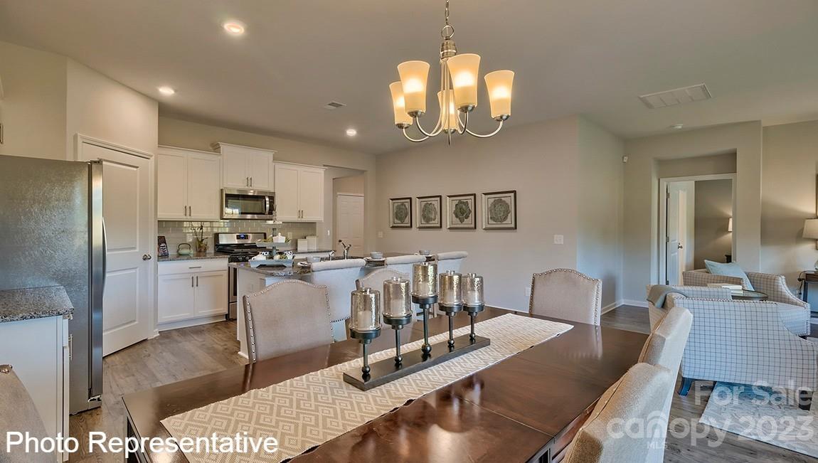 48 Burdock Road Fletcher, NC 28732 - Photo 19 of 30 a view of a dining room with furniture and a chandelier