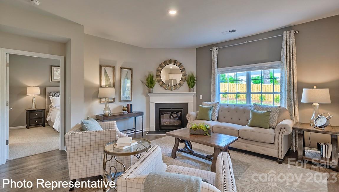 48 Burdock Road Fletcher, NC 28732 - Photo 20 of 30 a living room with furniture a fireplace and a table