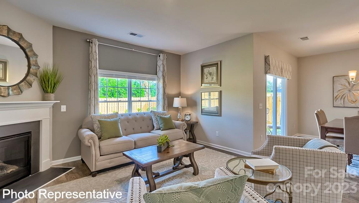 48 Burdock Road Fletcher, NC 28732 - Photo 21 of 30 a living room with furniture a fireplace and a table