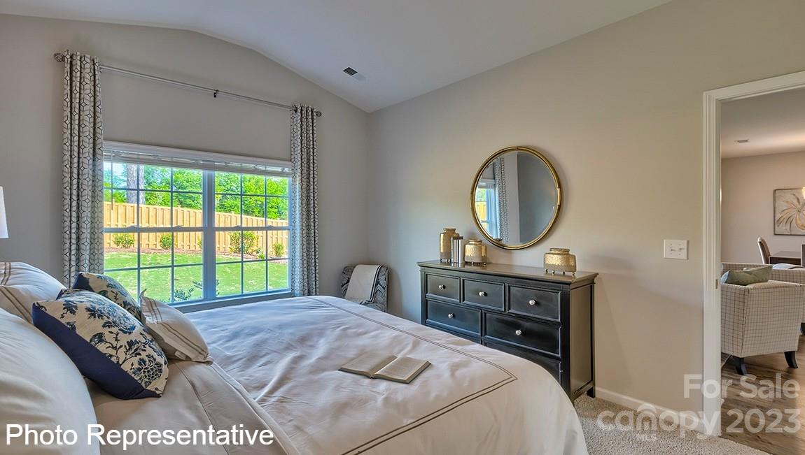 48 Burdock Road Fletcher, NC 28732 - Photo 24 of 30 a bedroom with a bed a mirror and a window