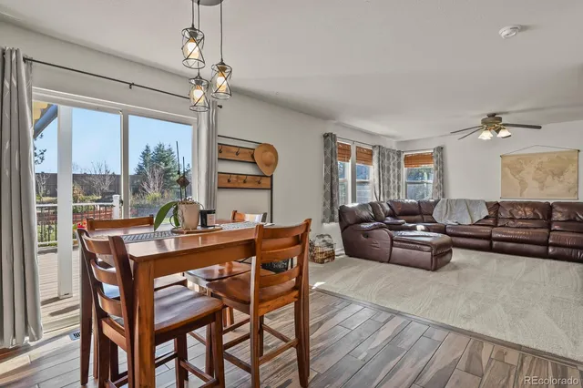 a living room with furniture a large window and a table