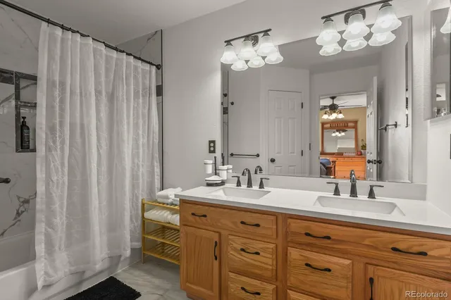 a bathroom with a double vanity sink and a mirror