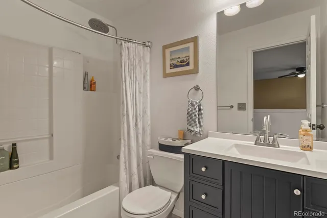 a bathroom with a double vanity sink toilet and shower