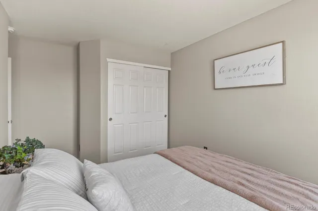 a bedroom with a bed and a couch