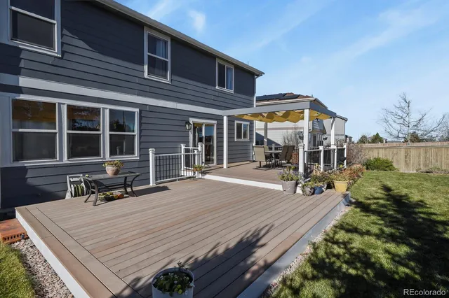 a view of a garden with a house in the background