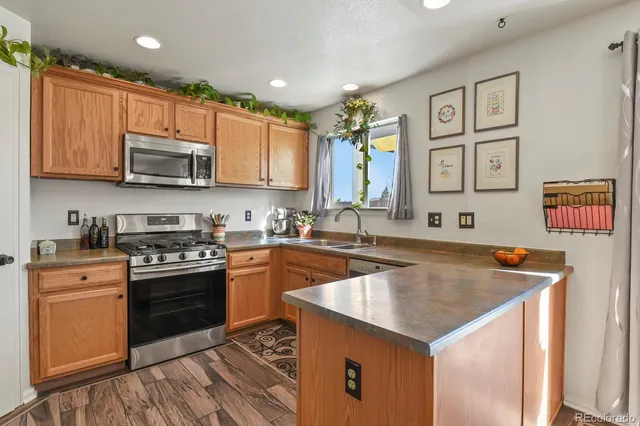 a kitchen with granite countertop a stove top oven sink and cabinets