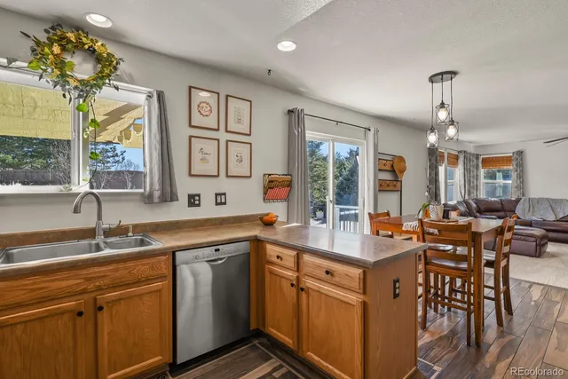 a kitchen with center island table and chairs