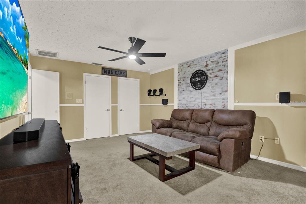 7487 River Country Drive Weeki Wachee, FL 34607 - Photo 40 of 53 a living room with furniture and a clock