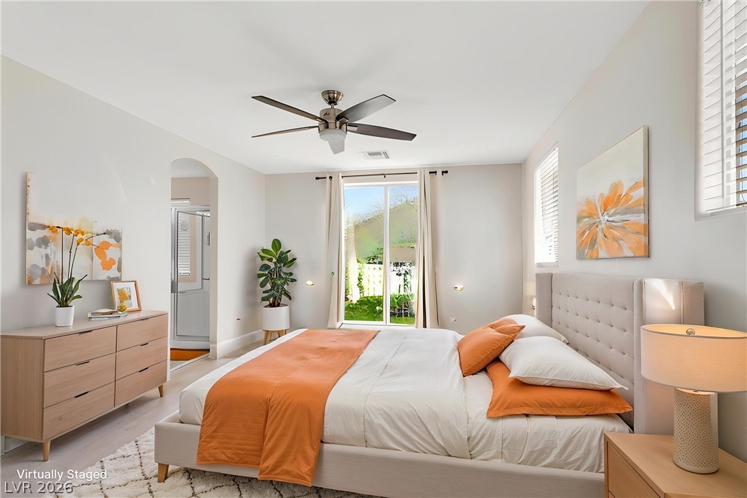 1019 Garnet Ridge Court Las Vegas, NV 89123 - Photo 15 of 34 Bedroom with access to exterior, arched walkways, ceiling fan, and light wood-style floors