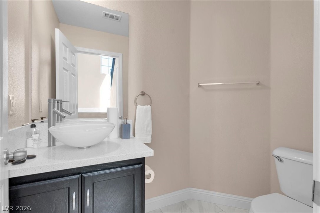 1019 Garnet Ridge Court Las Vegas, NV 89123 - Photo 20 of 34 Bathroom with vanity and light marble finish floors
