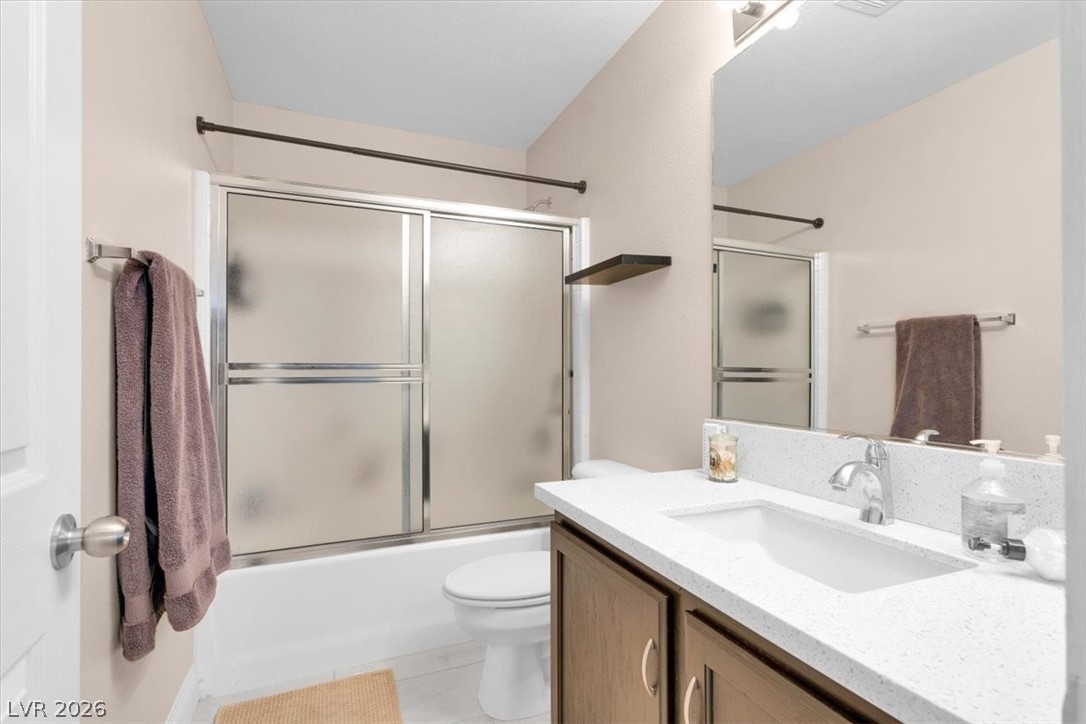 1019 Garnet Ridge Court Las Vegas, NV 89123 - Photo 21 of 34 Bathroom featuring vanity, combined bath / shower with glass door, and light tile patterned floors