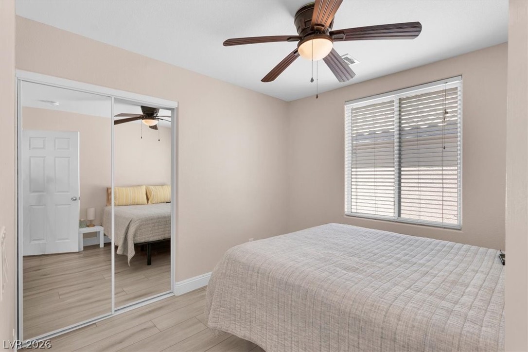 1019 Garnet Ridge Court Las Vegas, NV 89123 - Photo 24 of 34 Bedroom with a ceiling fan, light wood-type flooring, and a closet