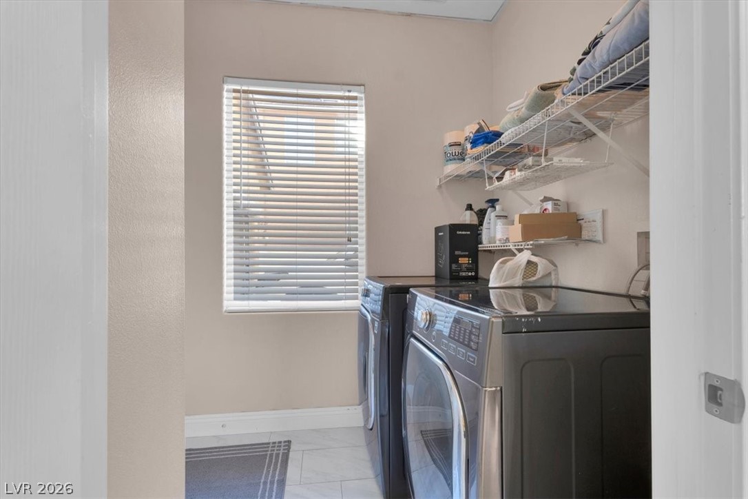 1019 Garnet Ridge Court Las Vegas, NV 89123 - Photo 29 of 34 Laundry area featuring washer and clothes dryer and light marble finish floors