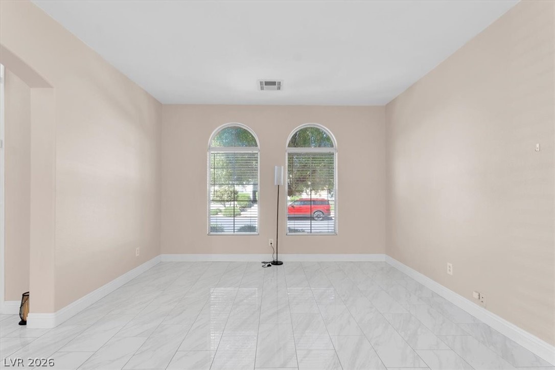 1019 Garnet Ridge Court Las Vegas, NV 89123 - Photo 31 of 34 Unfurnished room with baseboards and arched walkways