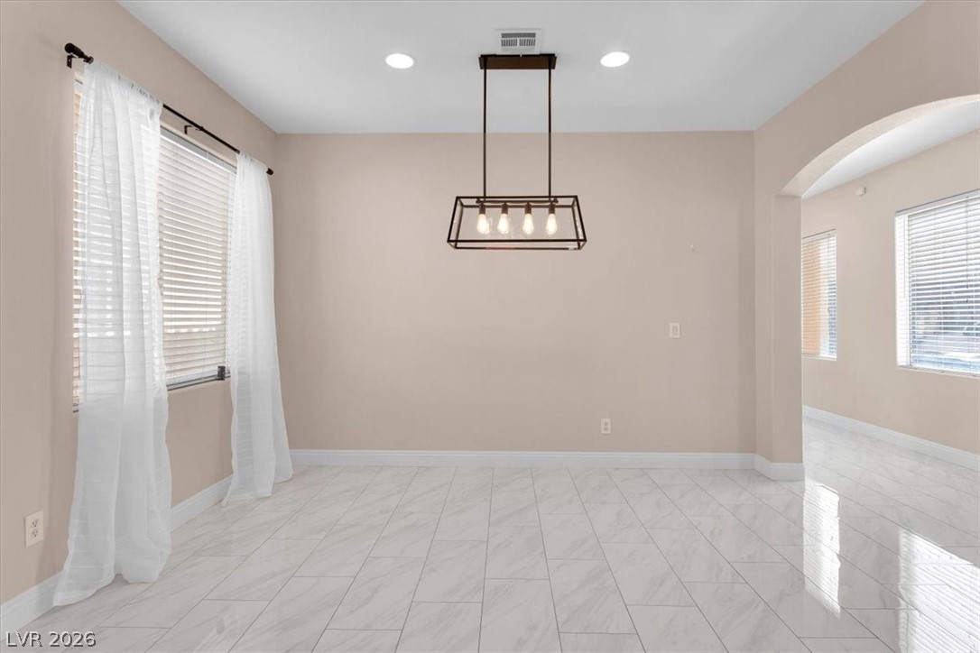 1019 Garnet Ridge Court Las Vegas, NV 89123 - Photo 32 of 34 Unfurnished dining area with arched walkways and recessed lighting